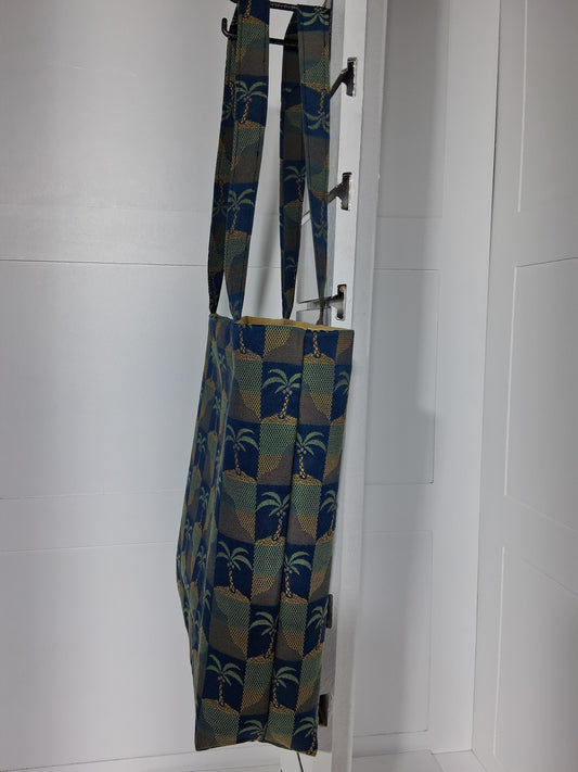 Side: "Side view of Pinpins Designs palm tree tapestry tote bag showing depth and long shoulder handles"