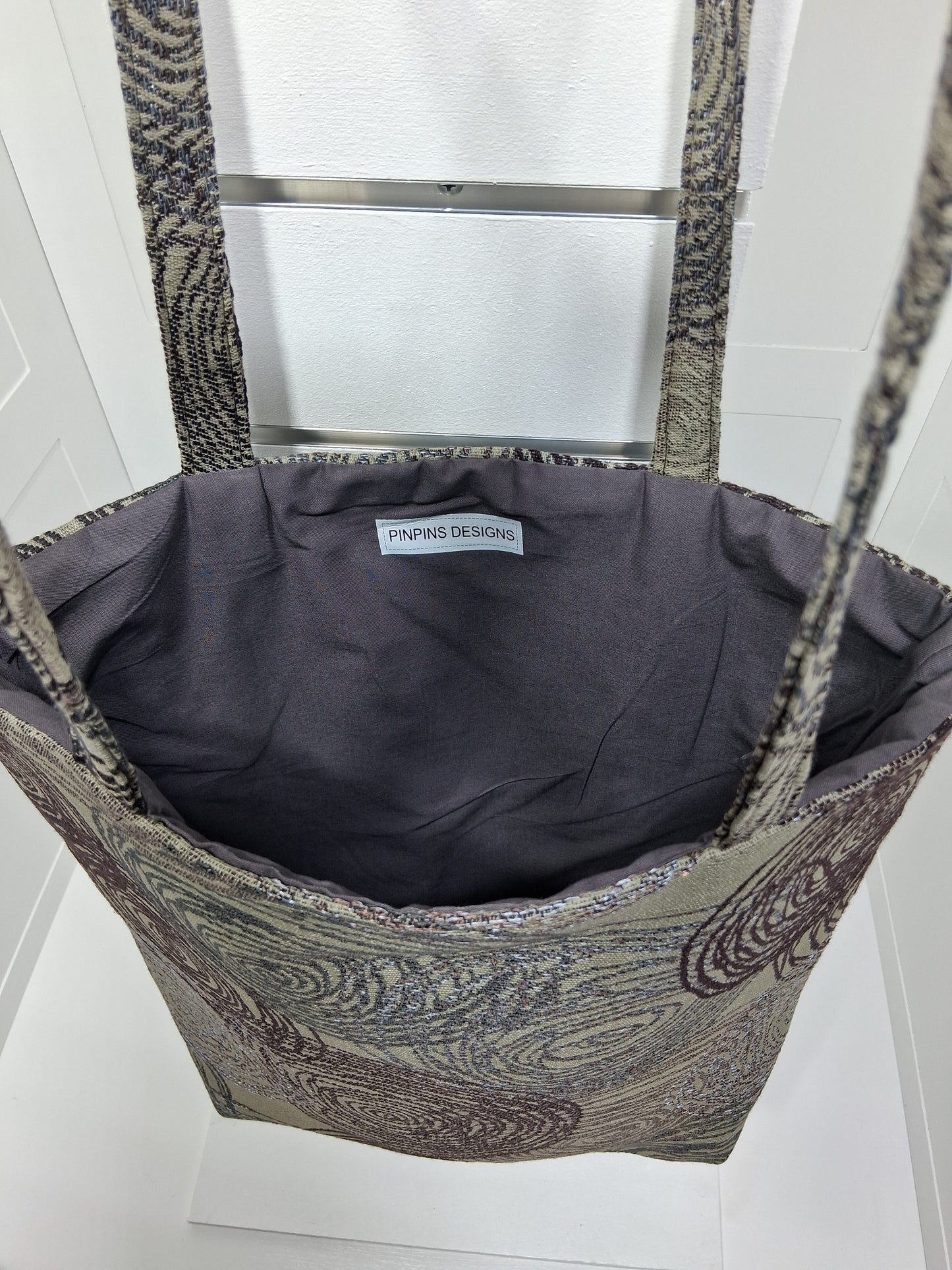 Interior: "Interior view of Pinpins Designs tote bag showing spacious charcoal gray lining and handmade Pinpins Designs label"