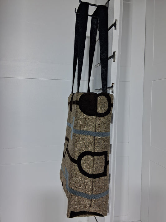 "Pinpins Designs handmade tote bag – side view, tan geometric abstract fabric with black straps"