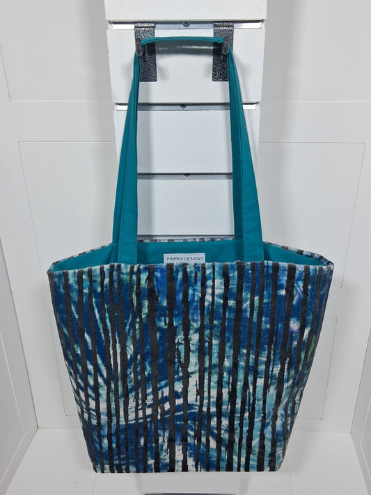 "Pinpins Designs handmade tote bag – front view, teal and navy shibori stripe fabric with teal lining"